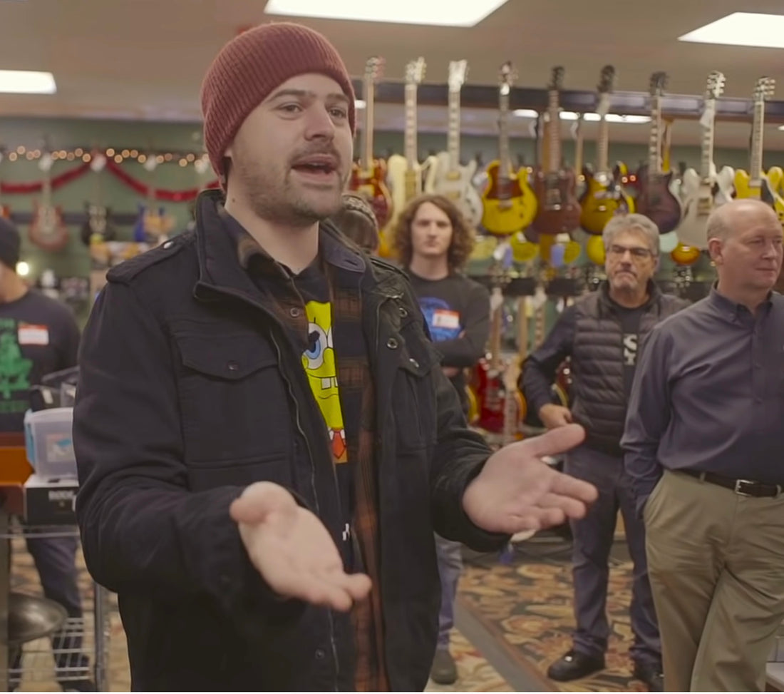 Watch what happens when 80 kids are given guitars at The Guitar Store!